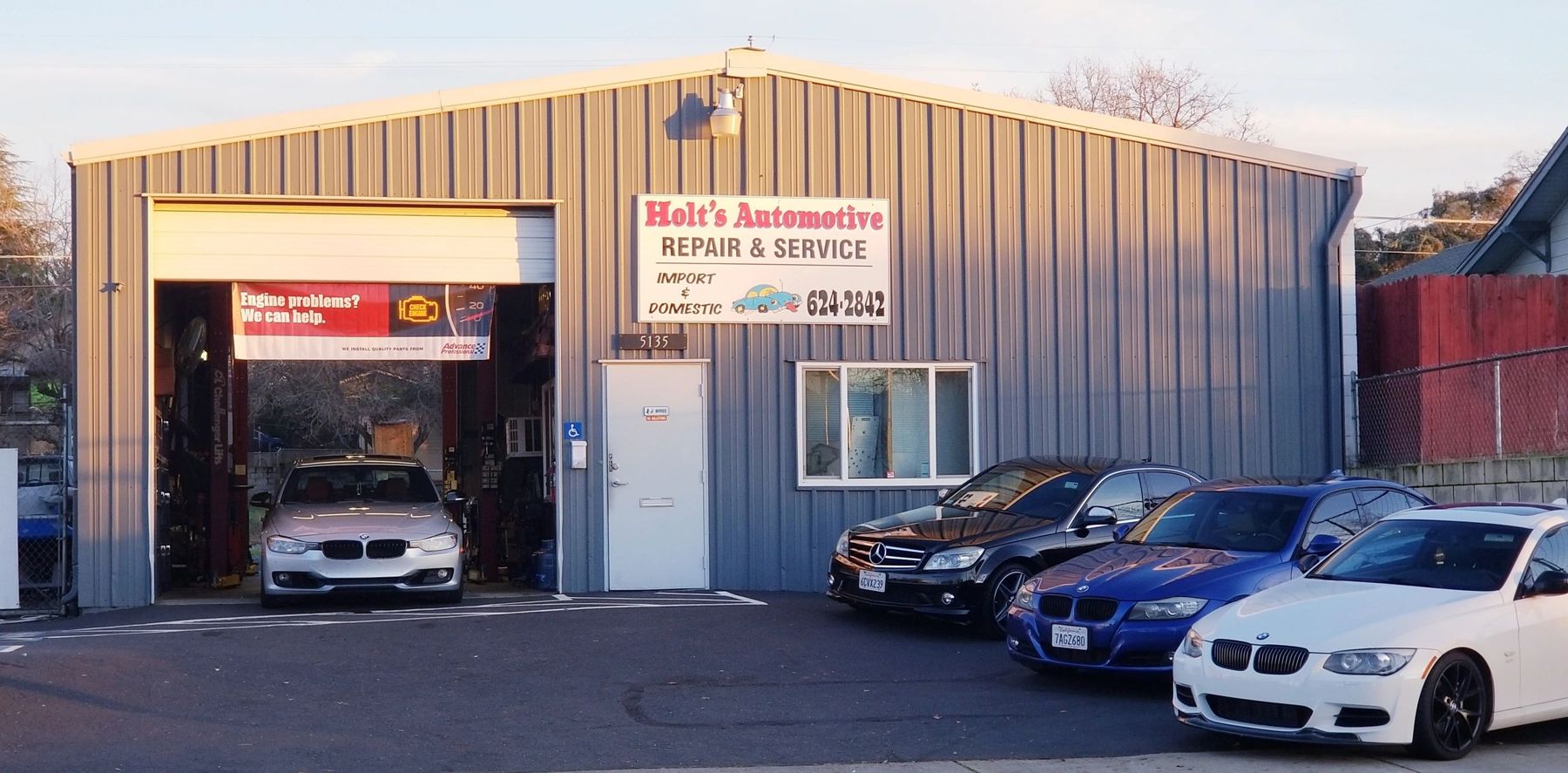 Holt's Automotive Repair shop building on Pacific Street in Rocklin with cars parked out front